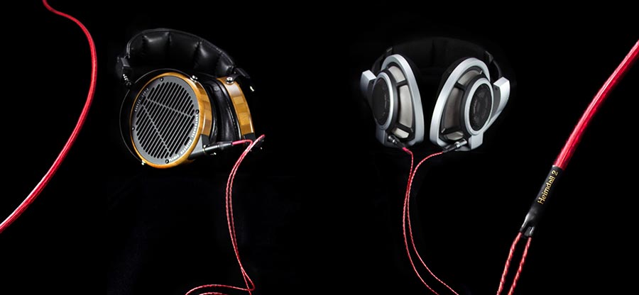 Two high-end headphones connected with Nordost Heimdall 2 headphone cables on a black backdrop
