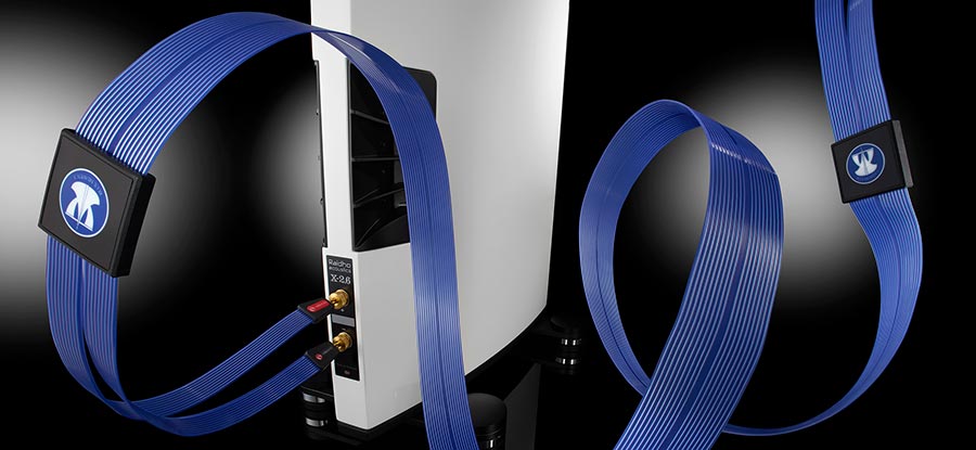 Blue Heaven 3 speaker cables connected to white loudspeakers in a modern high-end system