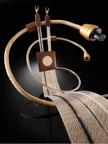 Close-up of premium Nordost speaker and power cables with gold-plated terminations and wood details
